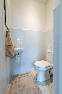 a bathroom with a toilet and a sink at Sophisticated Old town apartment by Polo Apartments in Kaunas