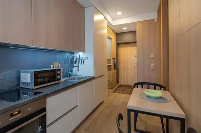 a kitchen with a small table and a microwave at Deluxe river view apartment by Polo Apartment in Kaunas