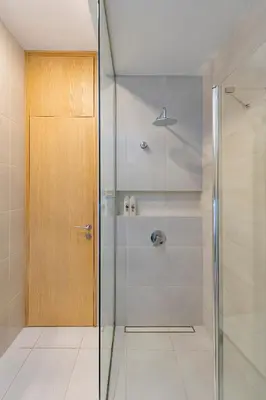 a shower with a glass door in a bathroom at Deluxe river view apartment by Polo Apartment in Kaunas