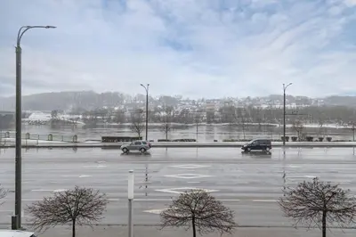 a parking lot with cars in a parking lot at Deluxe river view apartment by Polo Apartment in Kaunas