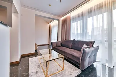 a living room with a couch and a glass table at Diamond svečių namai in Kaunas