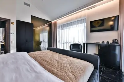 a hotel room with a bed and a desk at Diamond svečių namai in Kaunas