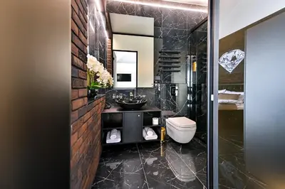 a black bathroom with a sink and a toilet at Diamond svečių namai in Kaunas