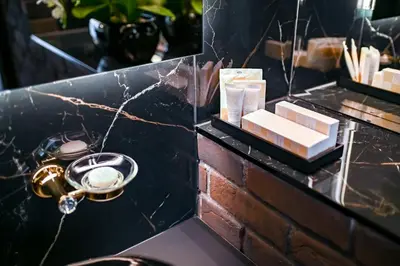 a bathroom with a black counter top with a sink at Diamond svečių namai in Kaunas