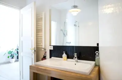 a bathroom with a white sink and a mirror at Bright apartment in Old Town by URBAN RENT in Vilnius