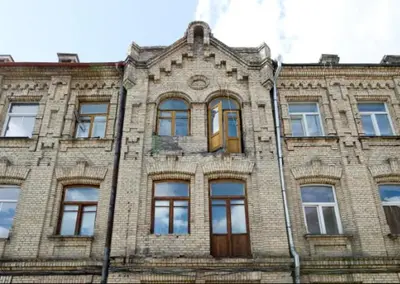 a brick building with windows and a wooden door at Bright apartment in Old Town by URBAN RENT in Vilnius