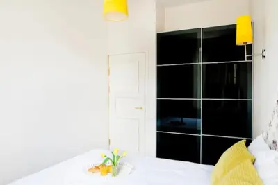 a room with a bed with a bowl of fruit on it at Bright apartment in Old Town by URBAN RENT in Vilnius