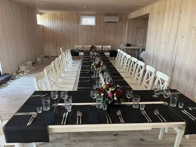 a long table in a room with tables and chairs at Bebryno slėnis in Staškūniškis