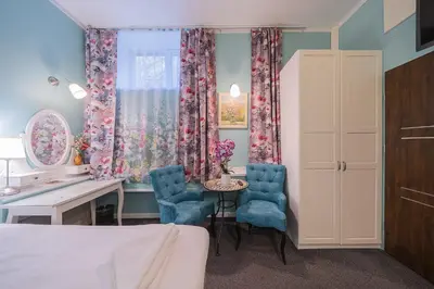 a bedroom with a bed and a table and chairs at Station Self Check-in Apartments - Lollo Stay in Vilnius