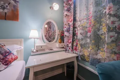 a bedroom with a dressing table and a mirror at Station Self Check-in Apartments - Lollo Stay in Vilnius