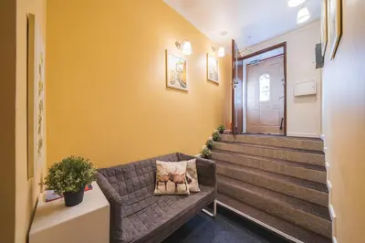 a living room with a couch in front of a door at Station Self Check-in Apartments - Lollo Stay in Vilnius