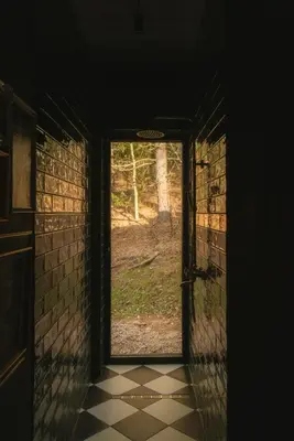 an open door in a room with a tiled floor at Aušrinės in Liškiava