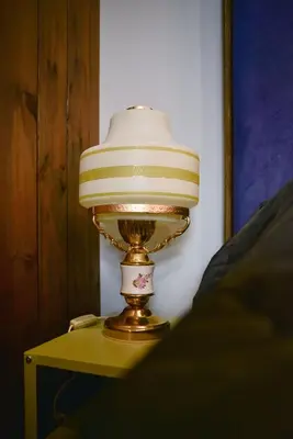 a lamp sitting on top of a table at Aušrinės in Liškiava