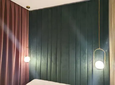 a bedroom with two lights and a green wall at Apartaments in Šiauliai center in Šiauliai