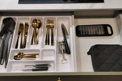 a white tray with silver utensils on a table at Apartaments in Šiauliai center in Šiauliai