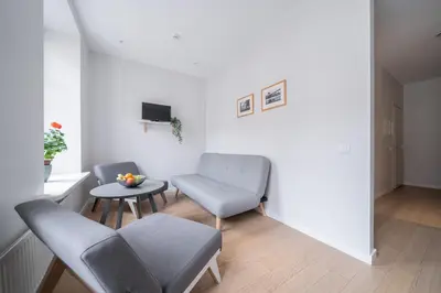 a living room with two chairs and a table at Lollo Luxury Residence - Lollo Stay in Vilnius