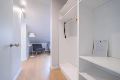 a white room with a glass door and a chair at Lollo Luxury Residence - Lollo Stay in Vilnius