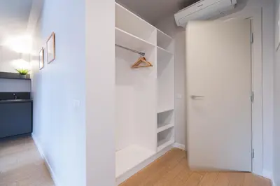 a hallway with a white closet with a door at Lollo Luxury Residence - Lollo Stay in Vilnius