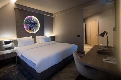 a hotel room with a large bed and a desk at CONTI HOTEL VILNIUS, Conference Centre, Restaurant & Bar in Vilnius