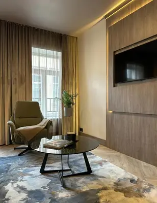 a living room with a chair and a coffee table at CONTI HOTEL VILNIUS, Conference Centre, Restaurant & Bar in Vilnius