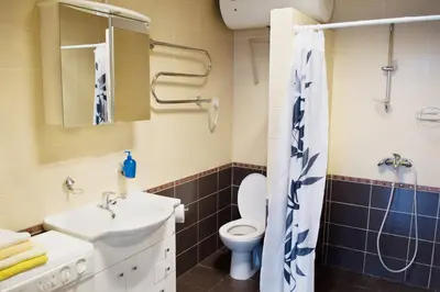 a bathroom with a sink and a toilet at Laisves alley 50 in Kaunas