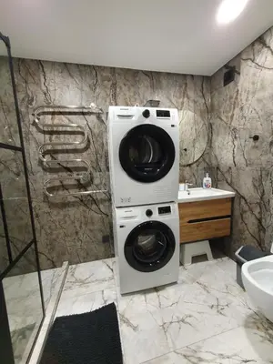 a washer and dryer in a bathroom at City apartment 2 bedrooms in Šiauliai