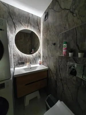 a bathroom with a sink and a mirror at City apartment 2 bedrooms in Šiauliai