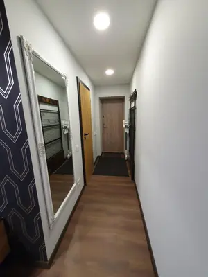 a hallway of a room with a mirror and a door at City apartment 2 bedrooms in Šiauliai