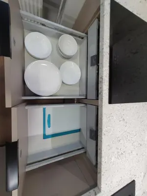 four white plates and bowls in a refrigerator at City apartment 2 bedrooms in Šiauliai