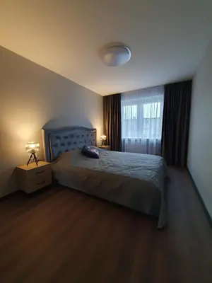 a bedroom with a large bed and a window at City apartment 2 bedrooms in Šiauliai