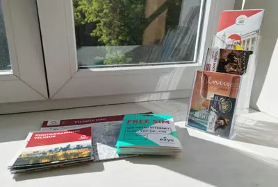 a pile of books sitting on a window sill at 4Work & Leisure I SELF-CHECKIN I 3PARKING I CENTRAL STATION DISTRICT - simpletone in Vilnius