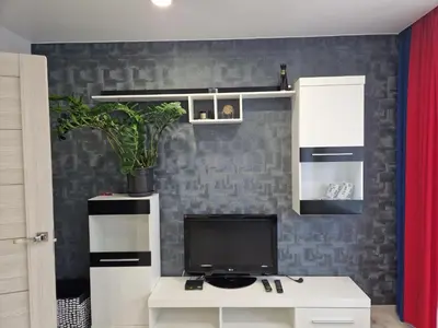 a living room with a tv and a white desk at MilaAna in Visaginas