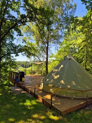 a yurt on a wooden deck in a park at 