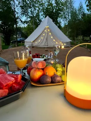 a table with fruit and drinks and a tent at 