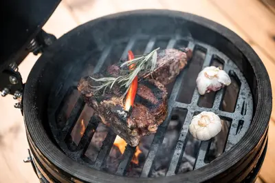 a steak and vegetables cooking on a grill at Namas MIŠKE in Lazdinė