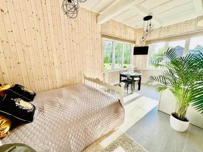 a bedroom with a bed and a table in a room at AGUONA ROYAL OASIS in Molėtai