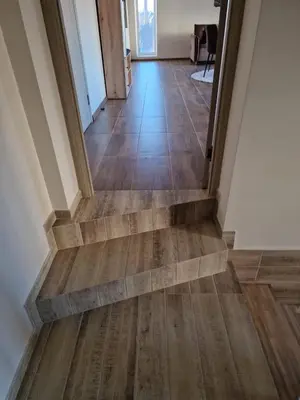a hallway with wood flooring in a house at Alvydo apartamentai in Kaunas