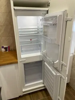 an empty refrigerator with its door open in a kitchen at Alvydo apartamentai in Kaunas