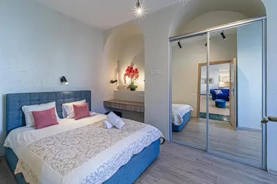 a bedroom with a bed and a walk in shower at Kaunas Heart Apartment in Kaunas