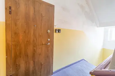 a wooden door in the corner of a room at Kaunas Heart Apartment in Kaunas