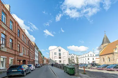 a city street with cars parked on the street at Kaunas Heart Apartment in Kaunas