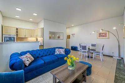 a living room with a blue couch and a table at Kaunas Heart Apartment in Kaunas