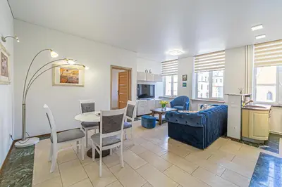a living room with a blue couch and a table at Kaunas Heart Apartment in Kaunas