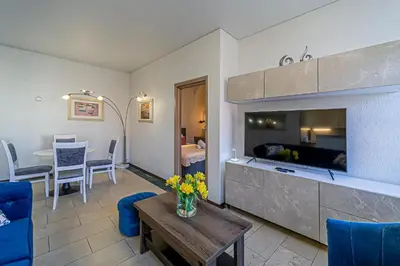 a living room with a fireplace and a dining room at Kaunas Heart Apartment in Kaunas