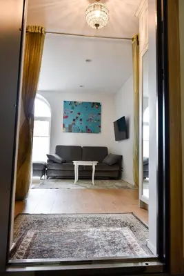a living room with a couch and a table at Mickeviciaus 11-11 in Šiauliai