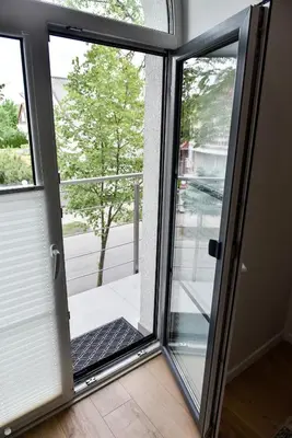 a sliding glass door with a view of a porch at Mickeviciaus 11-11 in Šiauliai