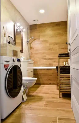a bathroom with a washing machine and a sink at Mickeviciaus 11-11 in Šiauliai