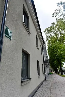 a building with a sign on the side of a street at Mickeviciaus 11-11 in Šiauliai