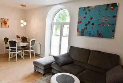 a living room with a couch and a table at Mickeviciaus 11-11 in Šiauliai