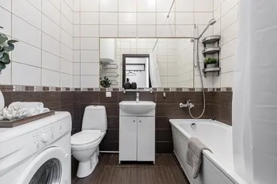 a bathroom with a toilet and a tub and a sink at Spacious City Centre Apartment with Parking SELF CHECK-IN in Vilnius